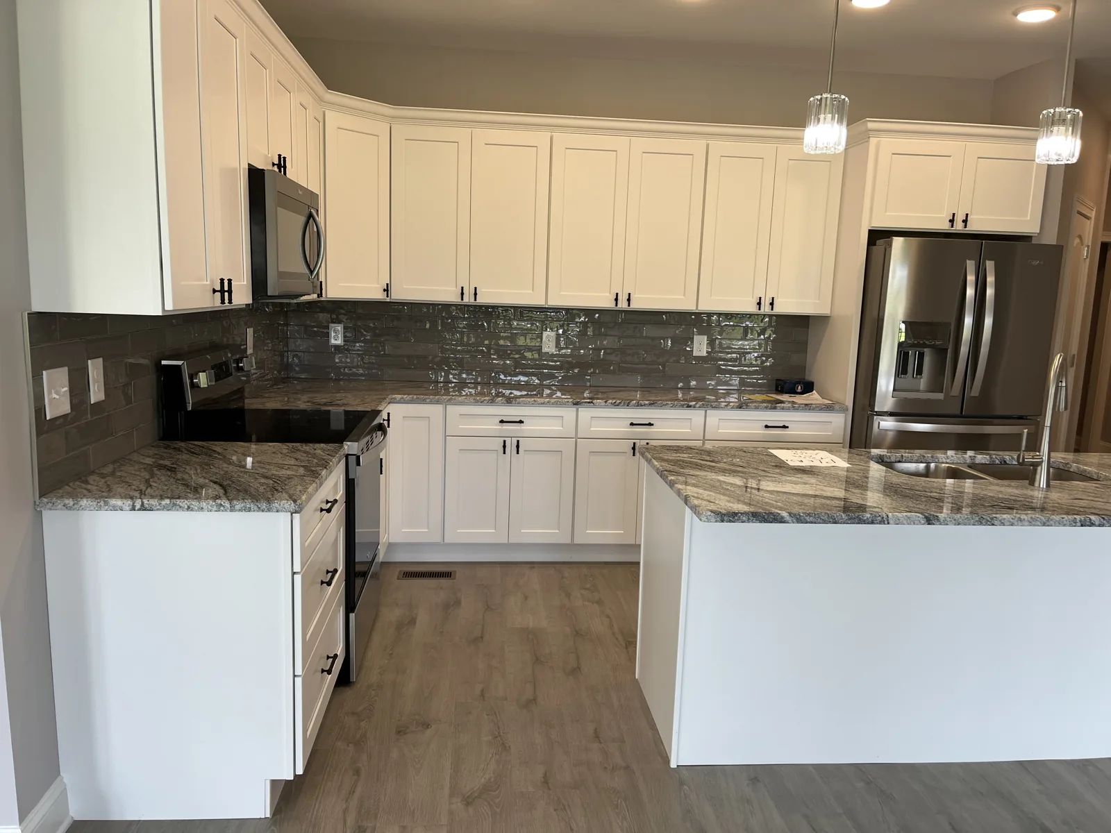 Kitchen with white cabinetry, granite countertops and stainless appliances at Old Silo Hill #2